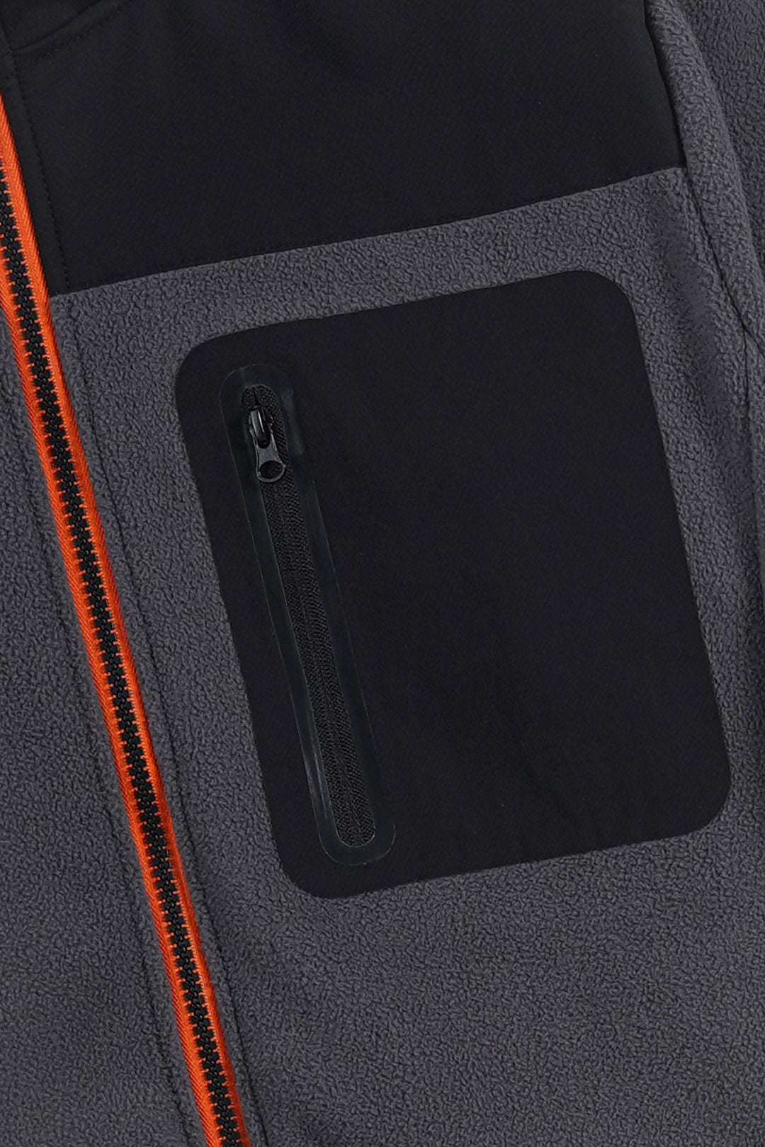 Close-up of a dark gray and black fleece jacket featuring a black zippered pocket and a bright orange zipper accent.