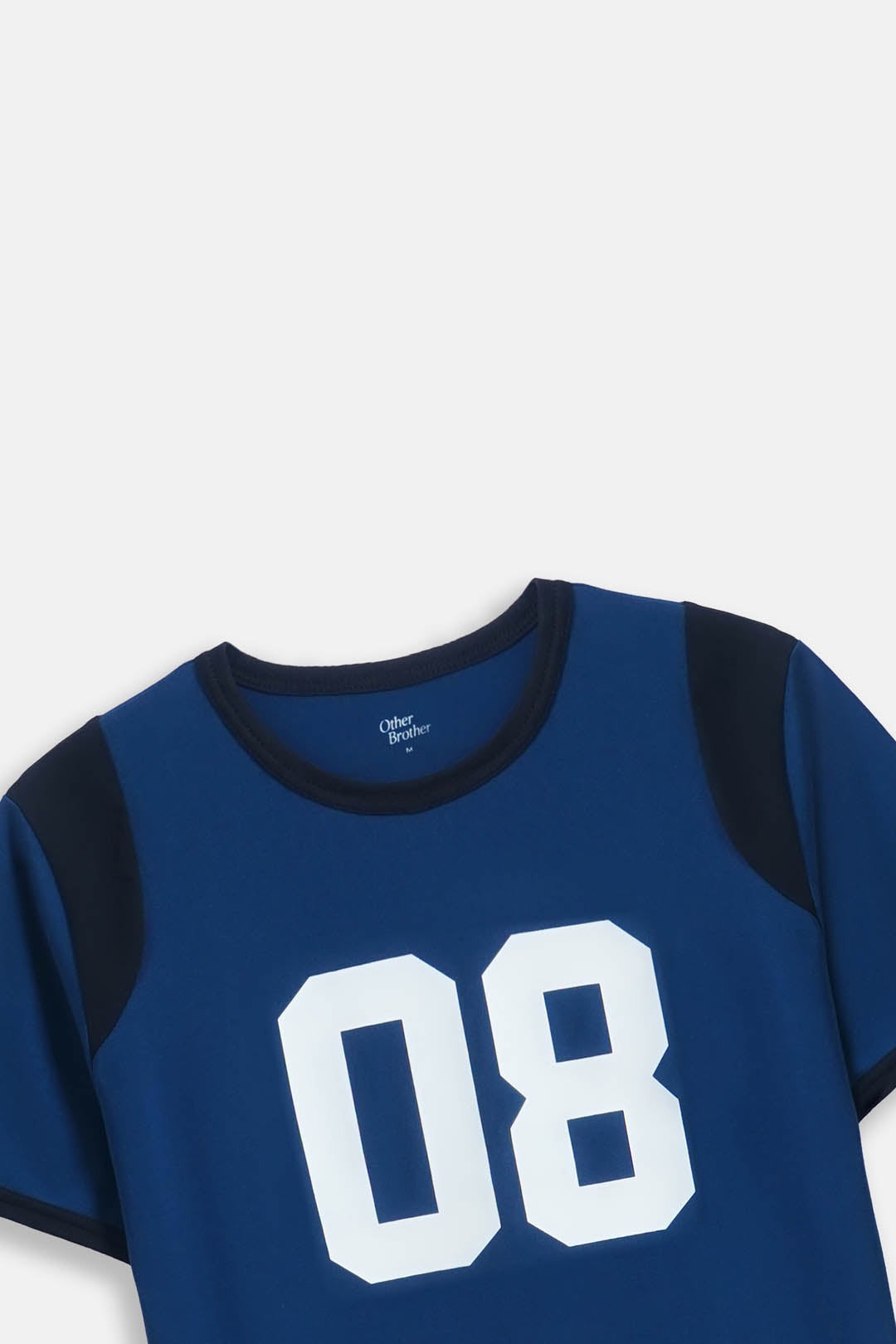 A close-up of a blue short-sleeve t-shirt with dark navy shoulder panels and a large white '08' printed on the front, shown against a light gray background.
