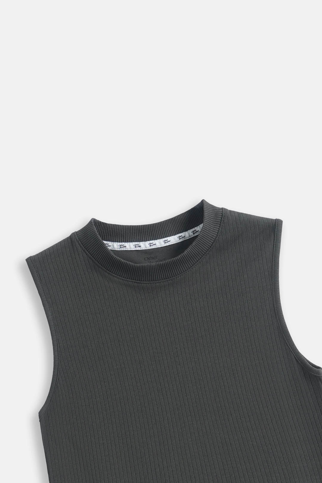 Close-up of a dark gray ribbed sleeveless top with a crew neck, showing the inner collar label.