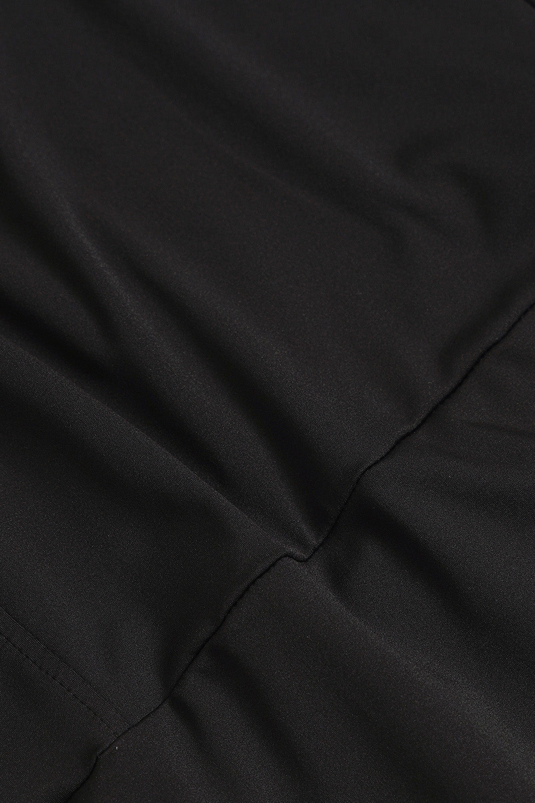Image of A close-up of black fabric with soft folds and a subtle sheen, showing the material texture and color.