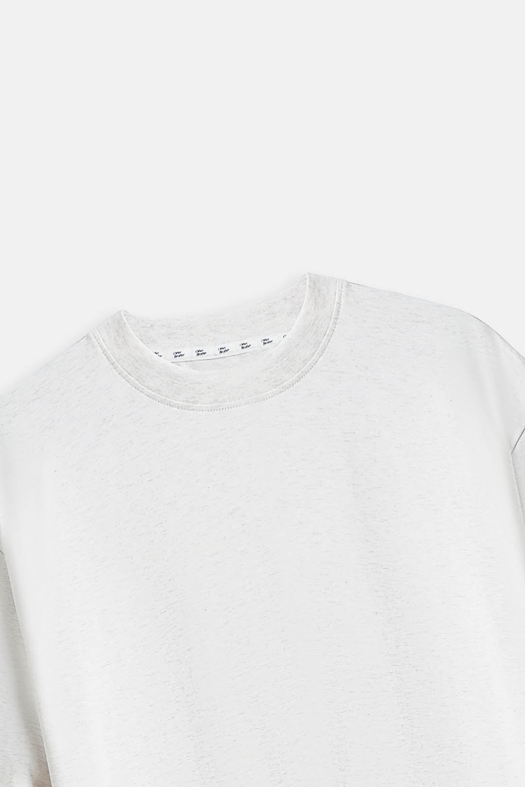 Image of A close-up of a light gray crewneck sweatshirt on a light gray background.